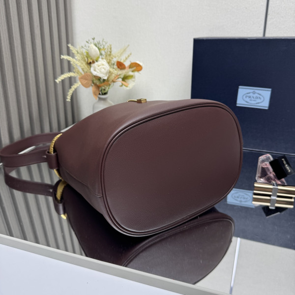 Pra*a buckle leather bucket bag with jeweled belt